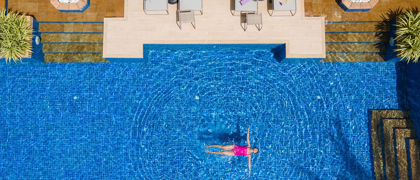 Aerial view of woman floating in a swimming pool 