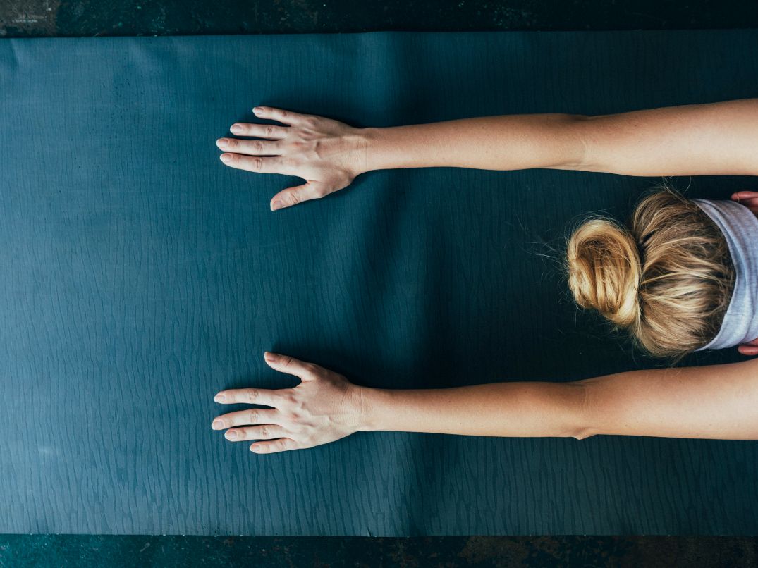 Individual stretching on yoga mat