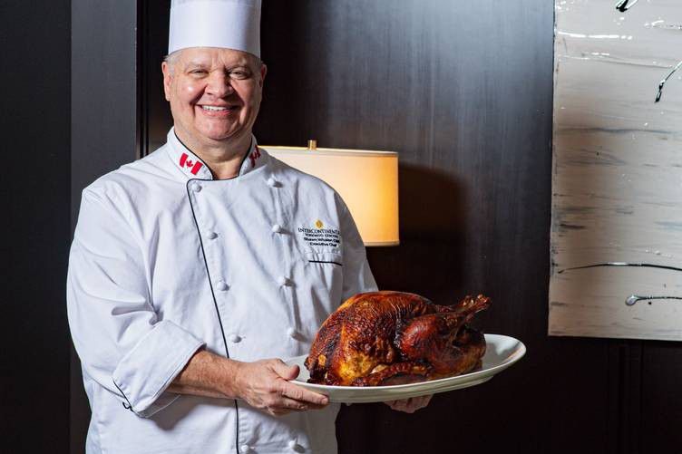 Chef at InterContinental Toronto holding a turkey plate