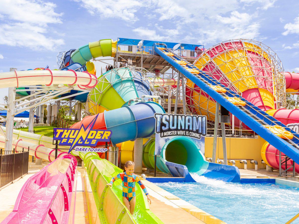 Colorful water park with slides and pools.