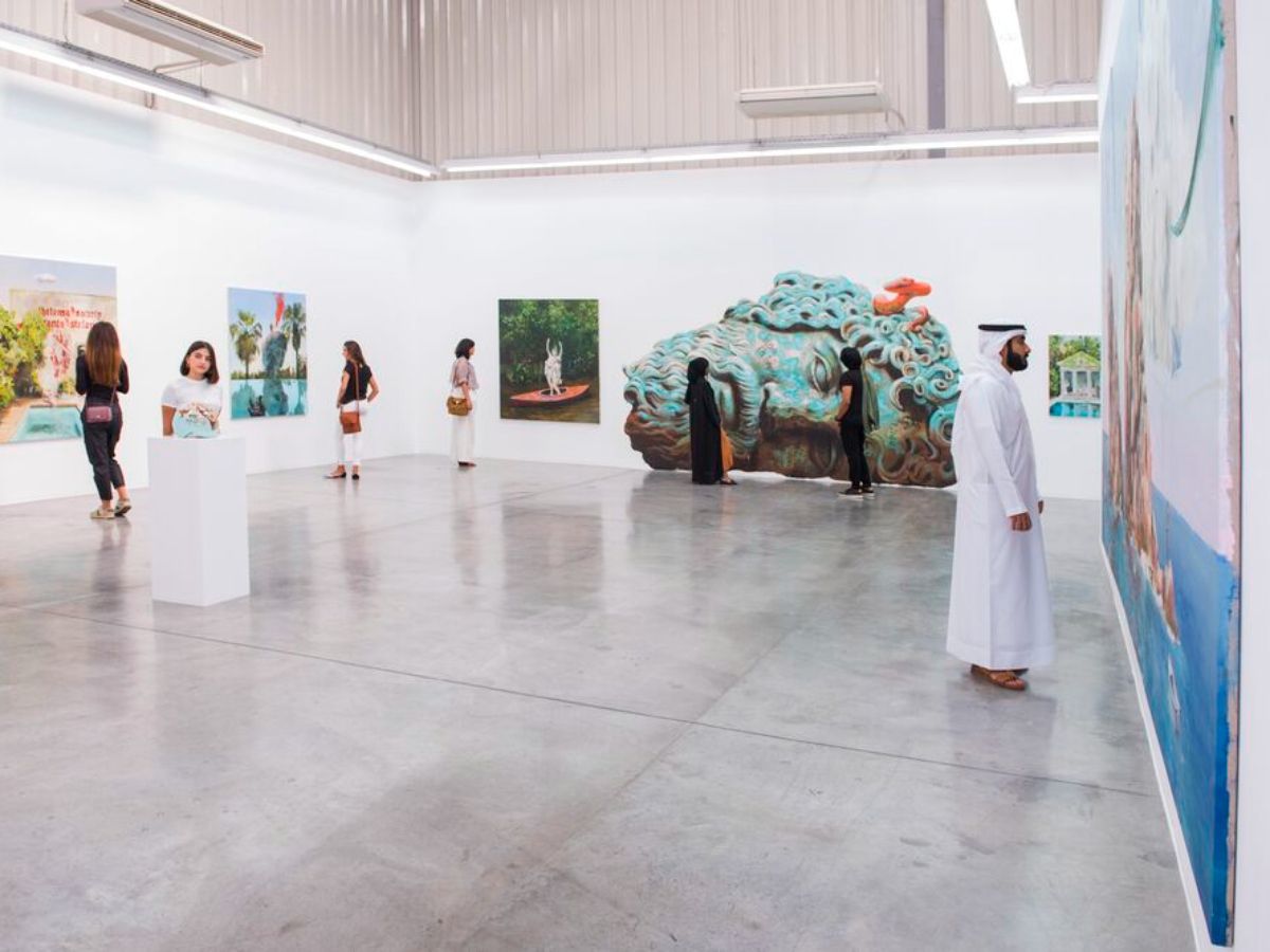 People viewing artwork inside a modern art gallery