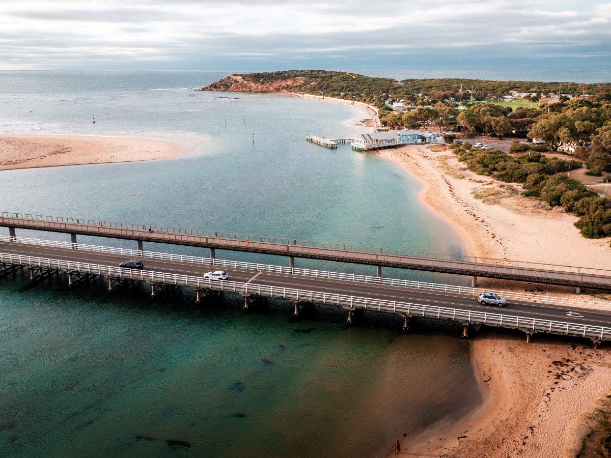 Aerial view of coastal bridge and sandy beach