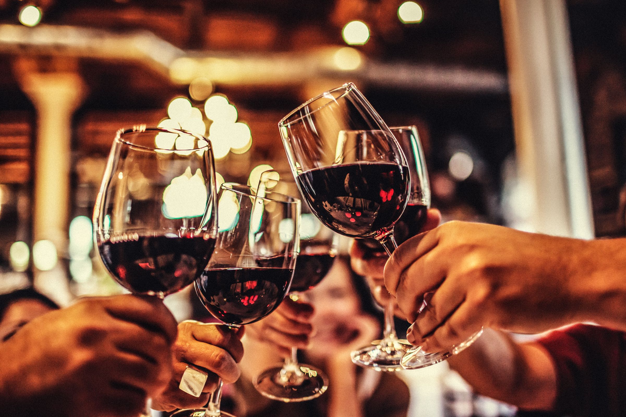 Group of friends toasting with red wine