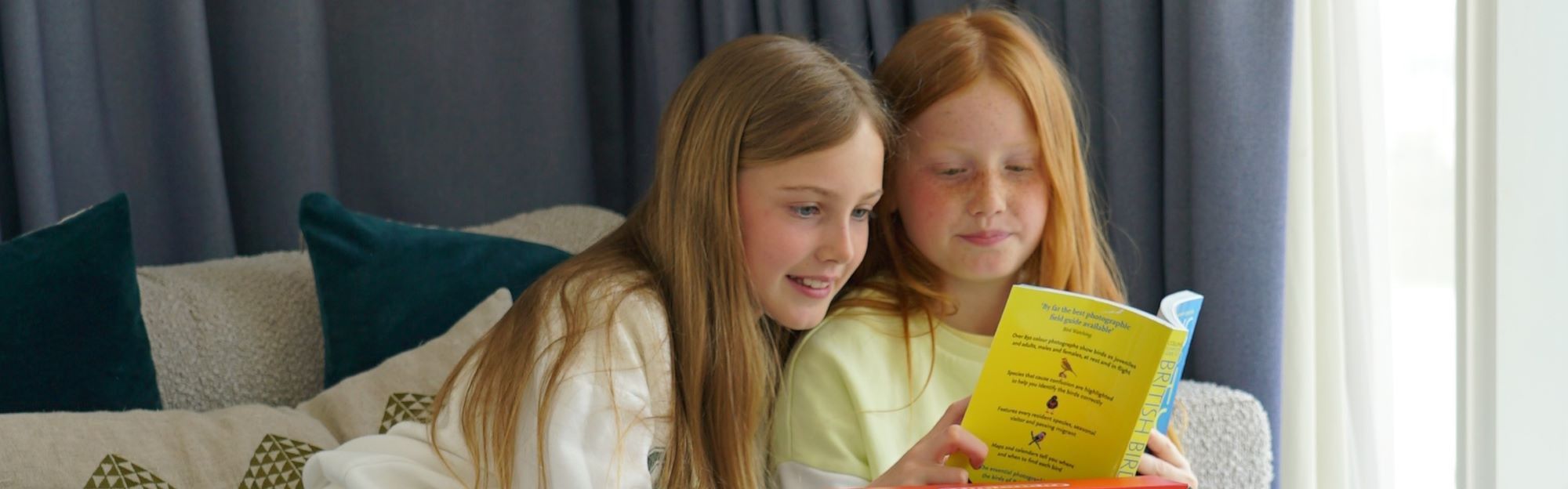 Sisters reading a book together