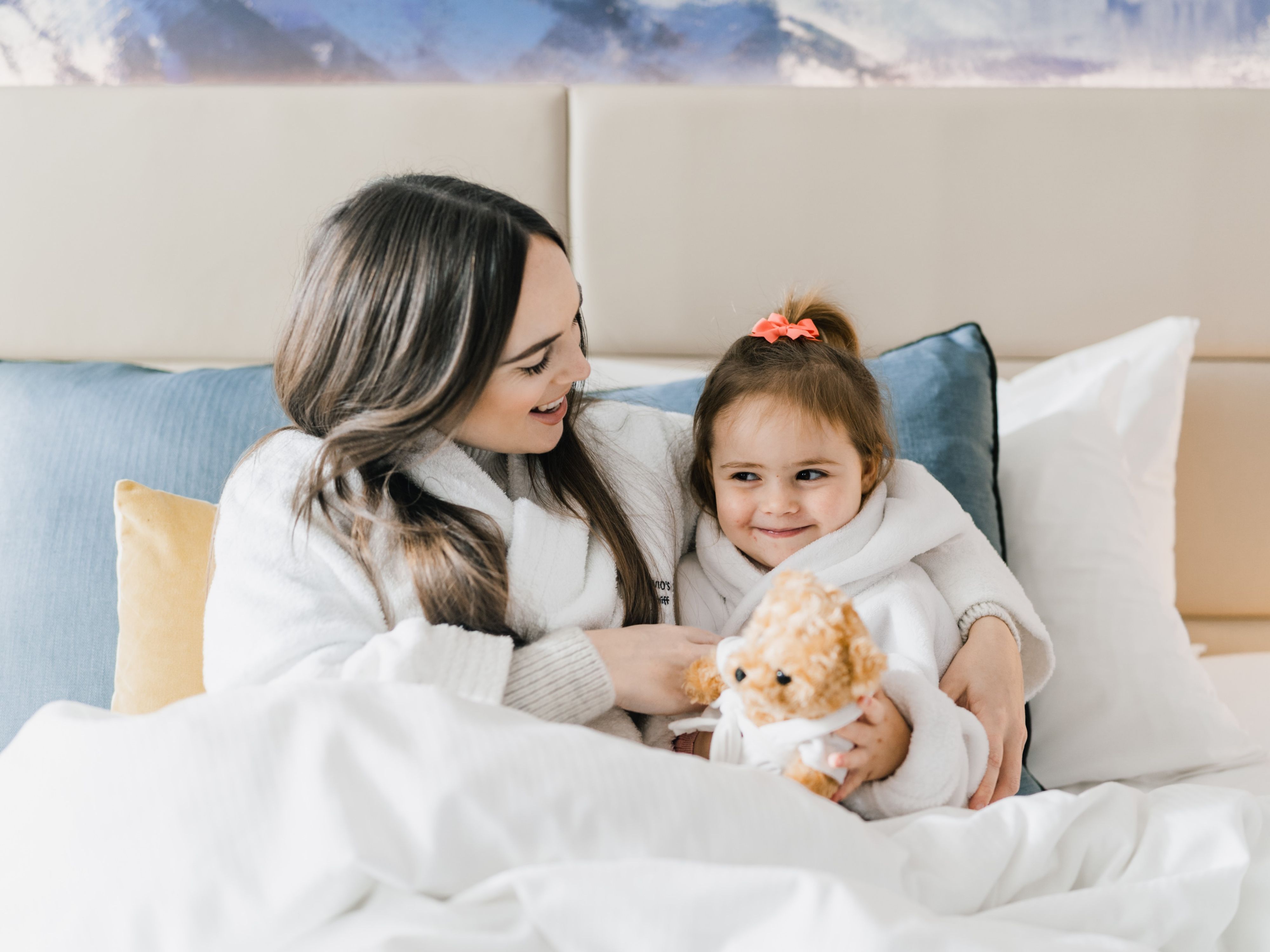 Mum and daughter in hotel bed