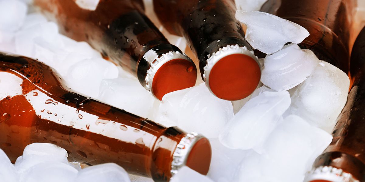 Classic beer bottles chilling on ice cubes