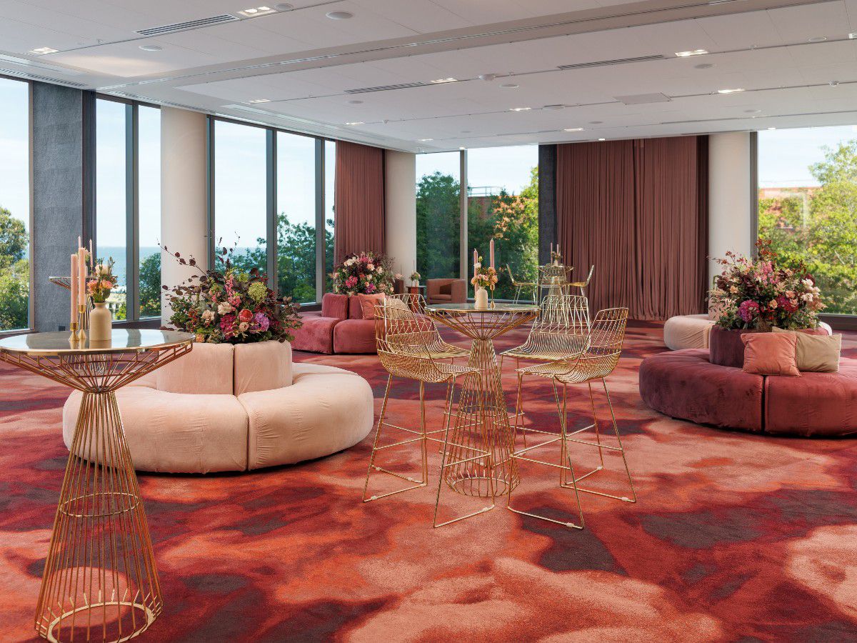 Elegant cocktail reception lounge with floral decor.