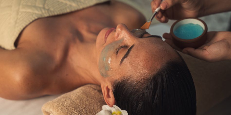 Facial treatment with mask application in luxury spa setting