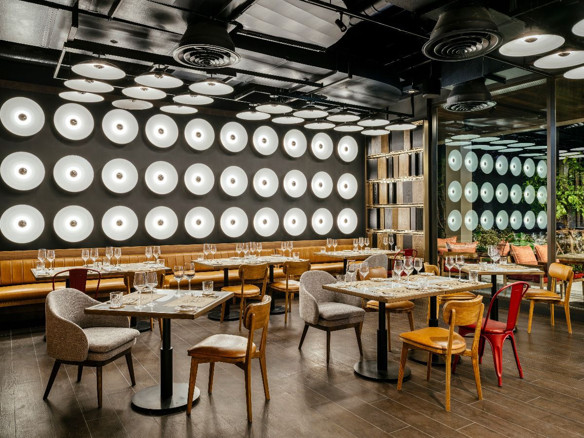 Modern restaurant interior with stylish lighting and dining seating.