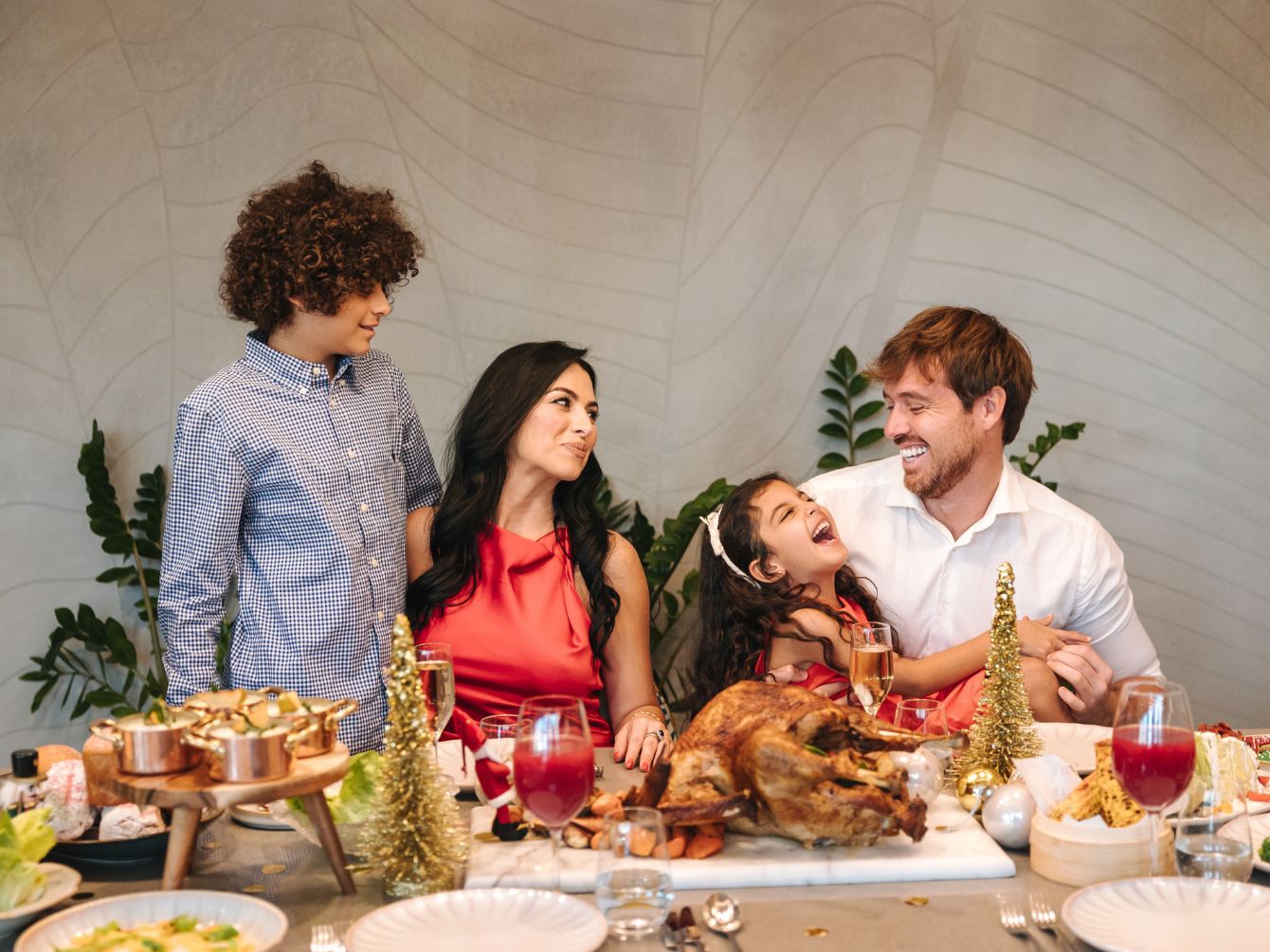 A family of 4 enjoying a festive meal.