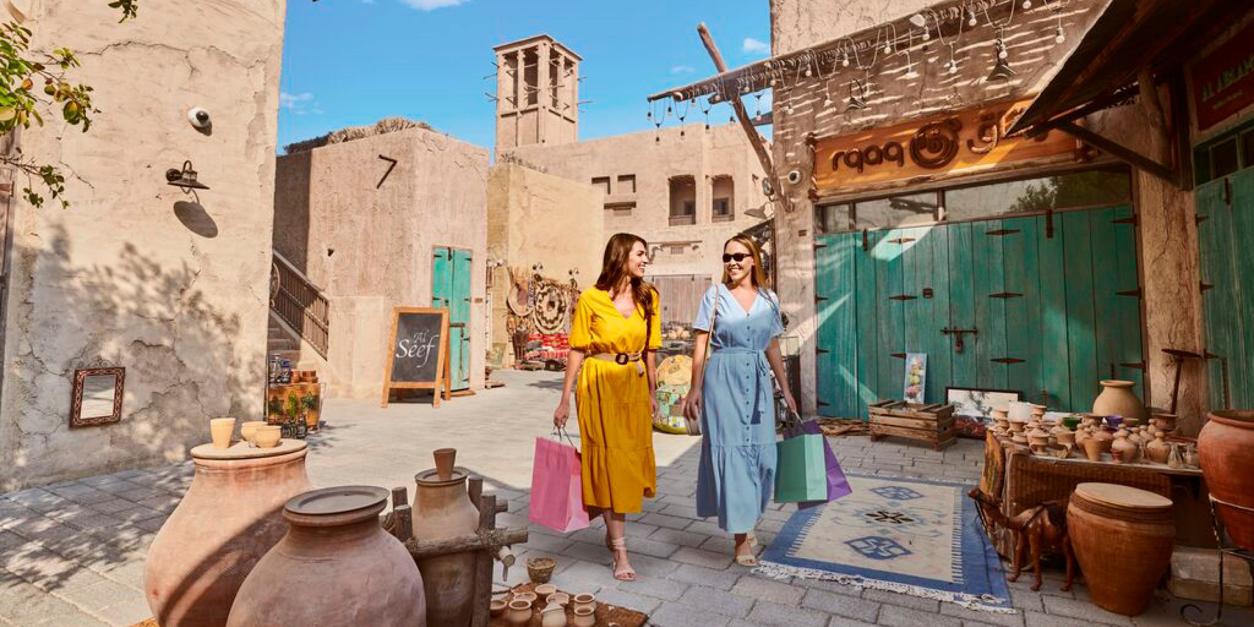 A collection of images to show many experiences in Dubai - the skyline view, sandunes, street shopping