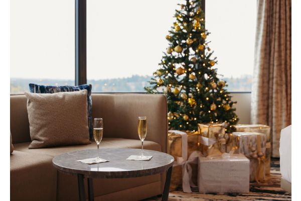 Couple toasting in front of Christmas tree