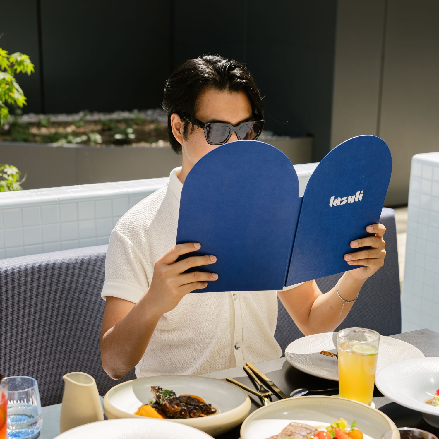 Man reading menu at LAZULI restaurant