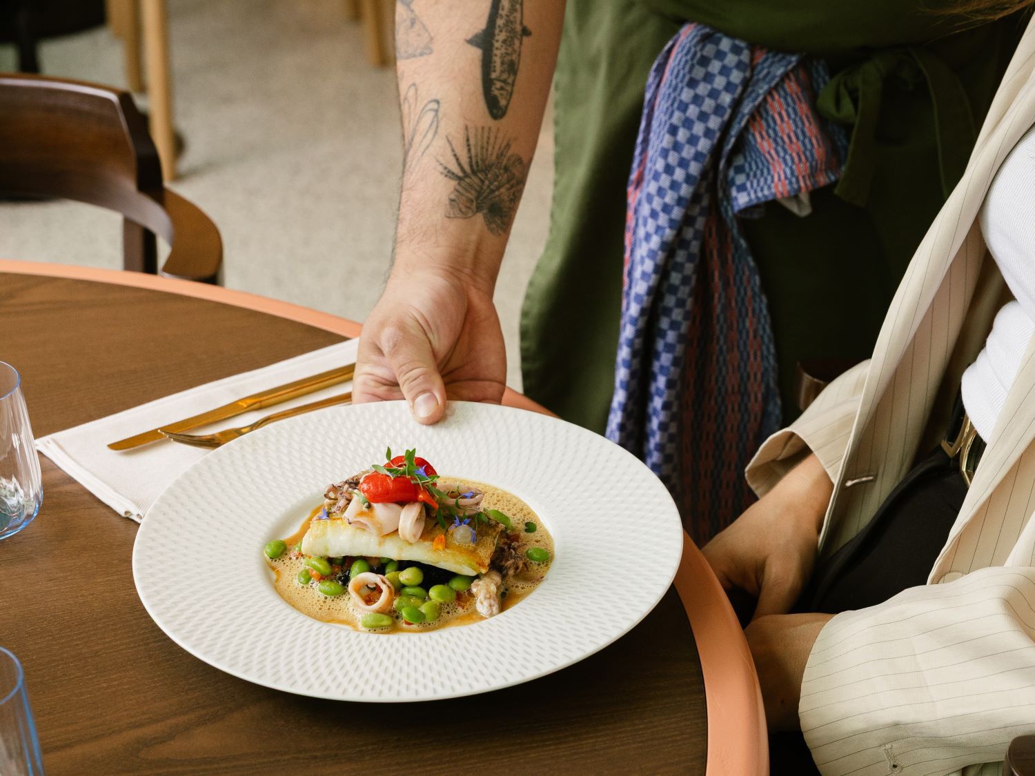 Chef serving meal to hotel guest