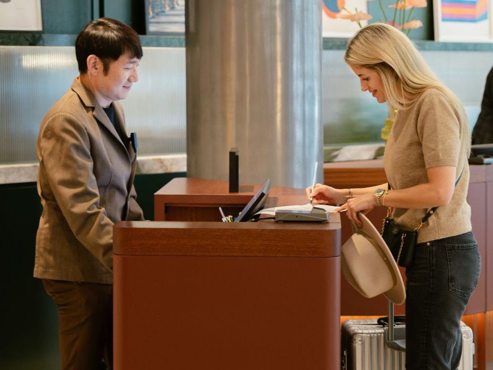 Woman checking in to hotel