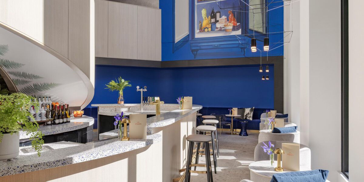 Elegant blue dining space with curved bar seating.