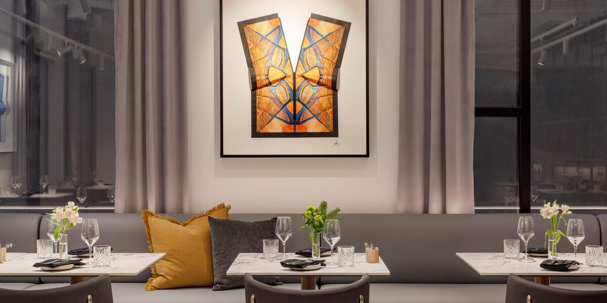 Elegant restaurant seating with artistic wall decor.