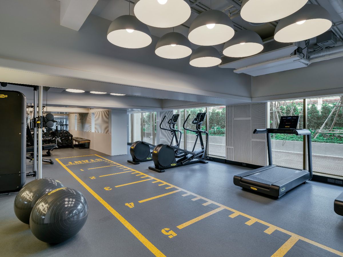Modern fitness center equipped with cardio machines and workout space.