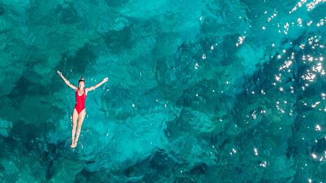 Woman floating in ocean