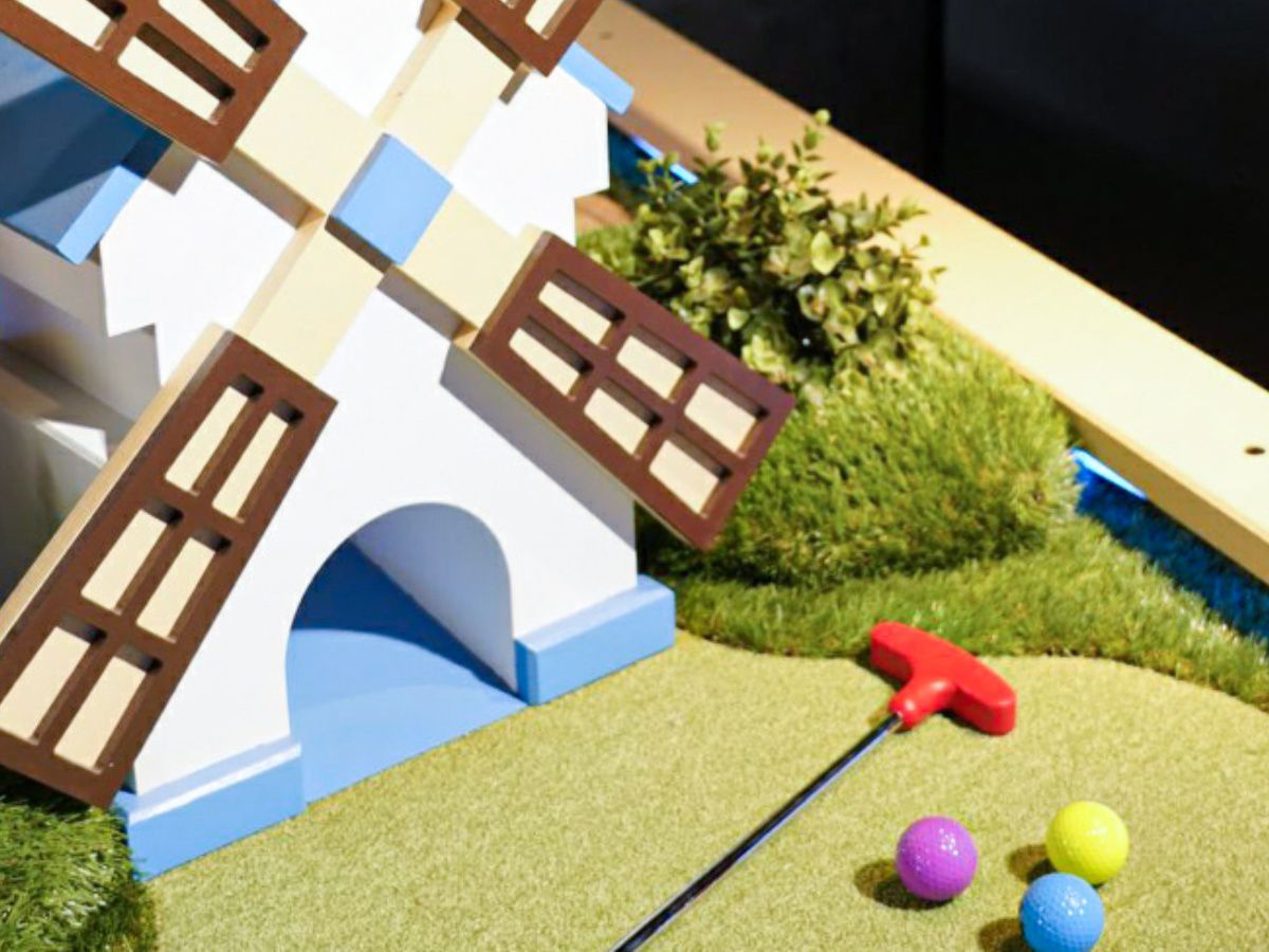 Mini golf windmill with colorful balls and putter