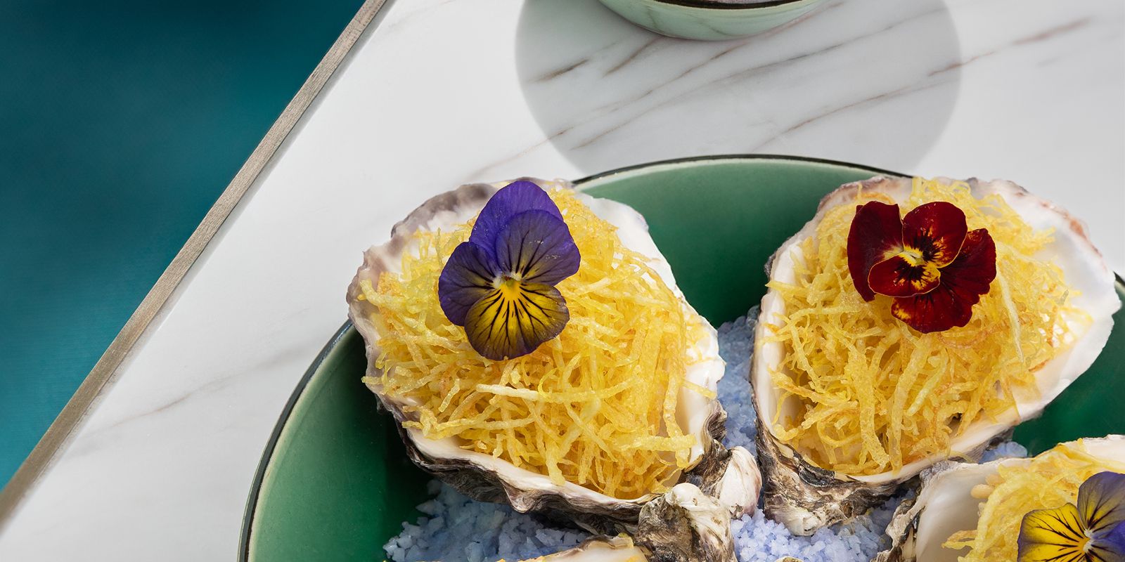Delicately crafted oysters topped with crisp flavors and floral elegance.