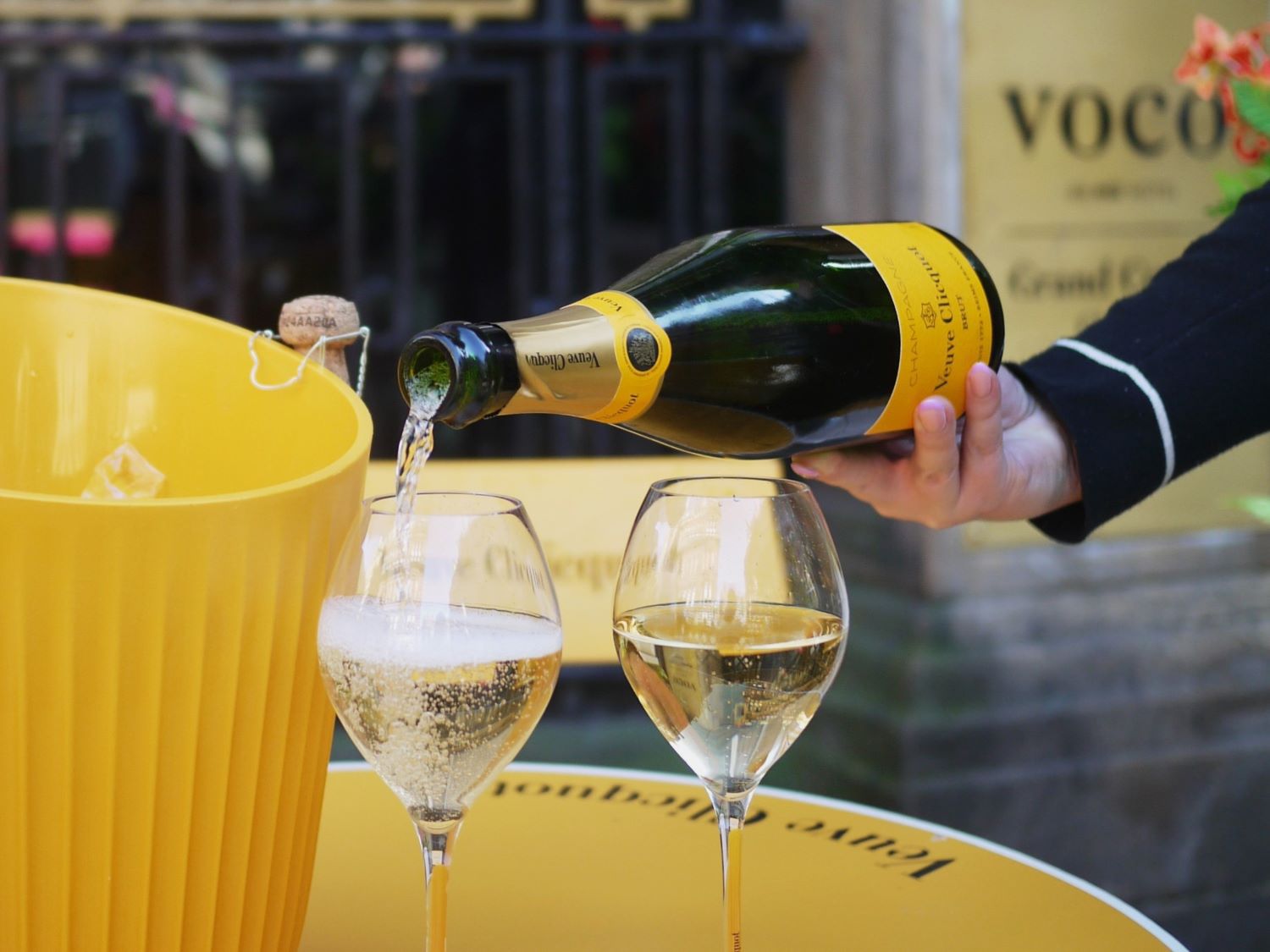 Pouring champagne into a champagne glass in vocos pop up bar in Glasgow