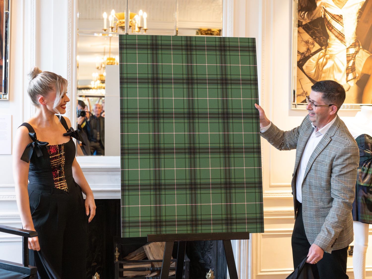 Siobhan Mackenzie holding up her tartan artwork