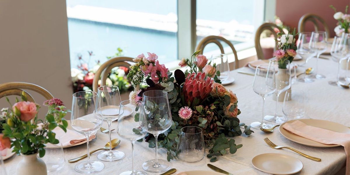 Elegant private dining table with floral centerpiece.