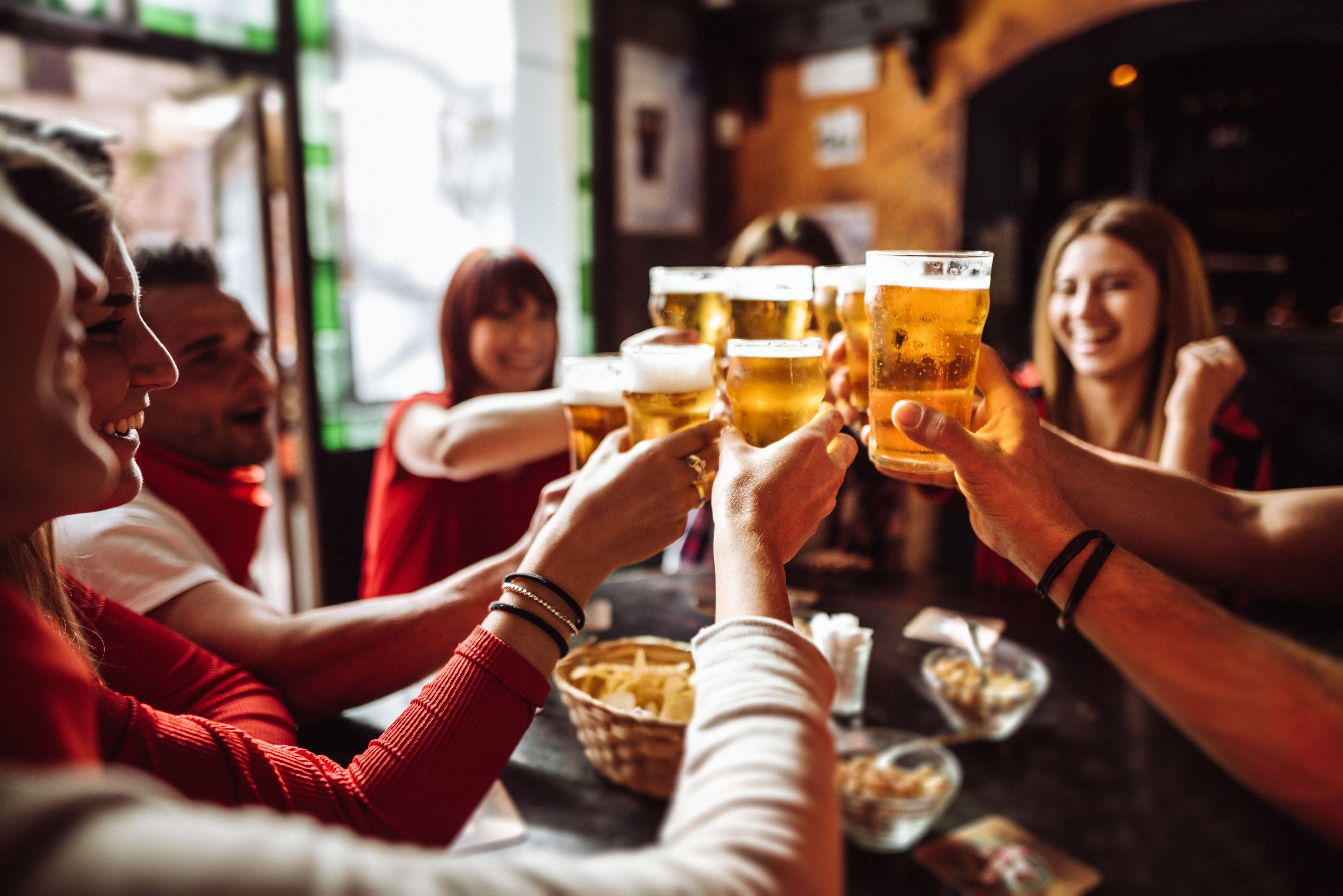 Group of friends toasting with beer 