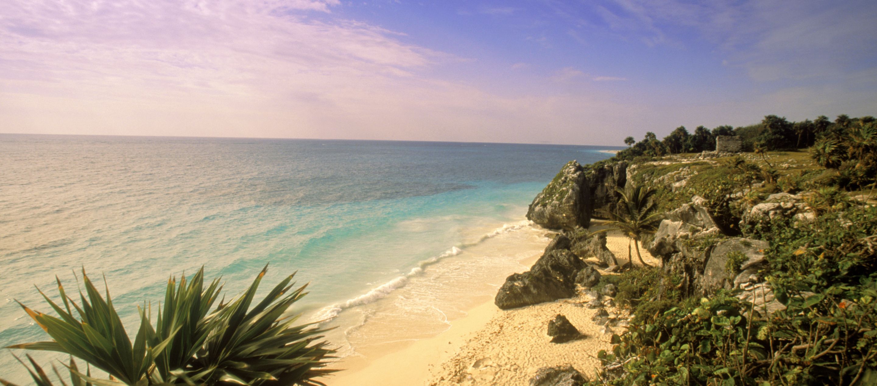 beach and rocky craggy cliff overlooking the ocean on yucatan peninsula
