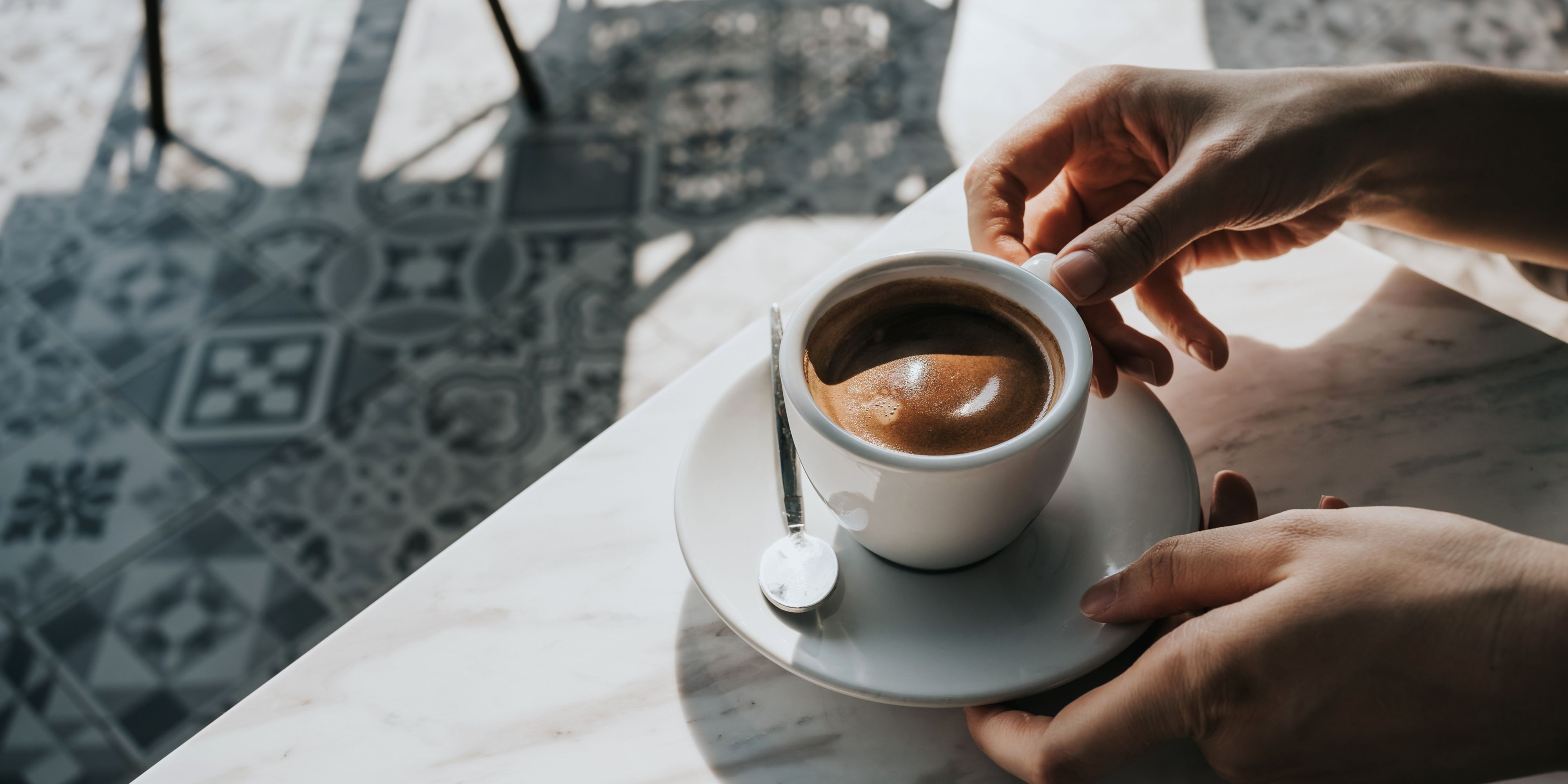 hands holding a cup of coffee