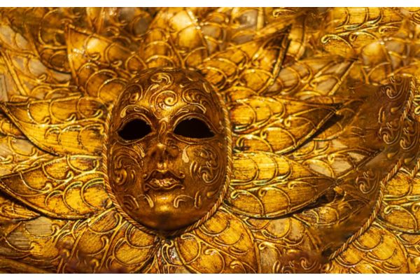 Gold Venetian-style mask with ornate decorative details