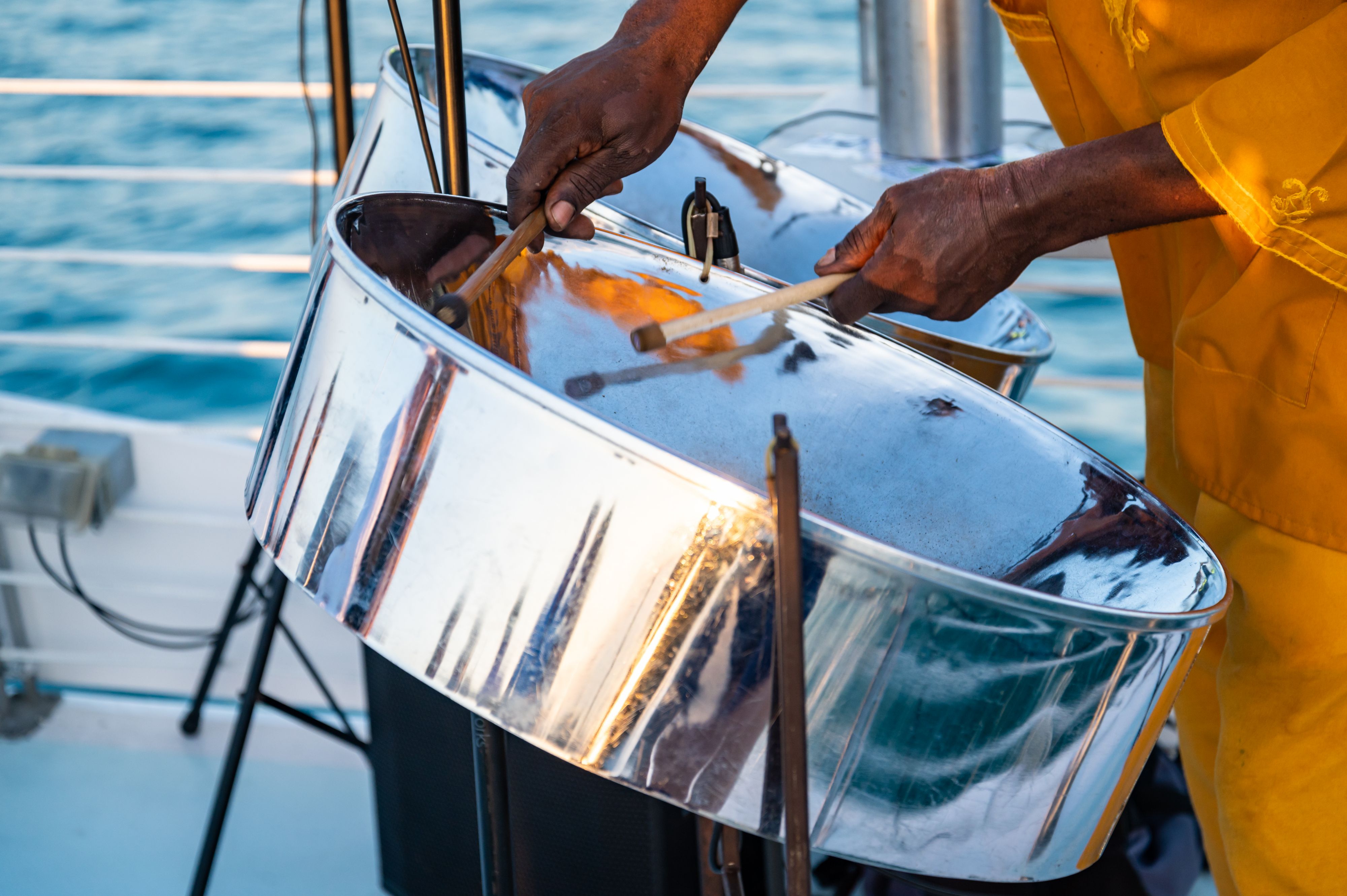 Close up of a a musician from Jamaica playing steel pan drums 