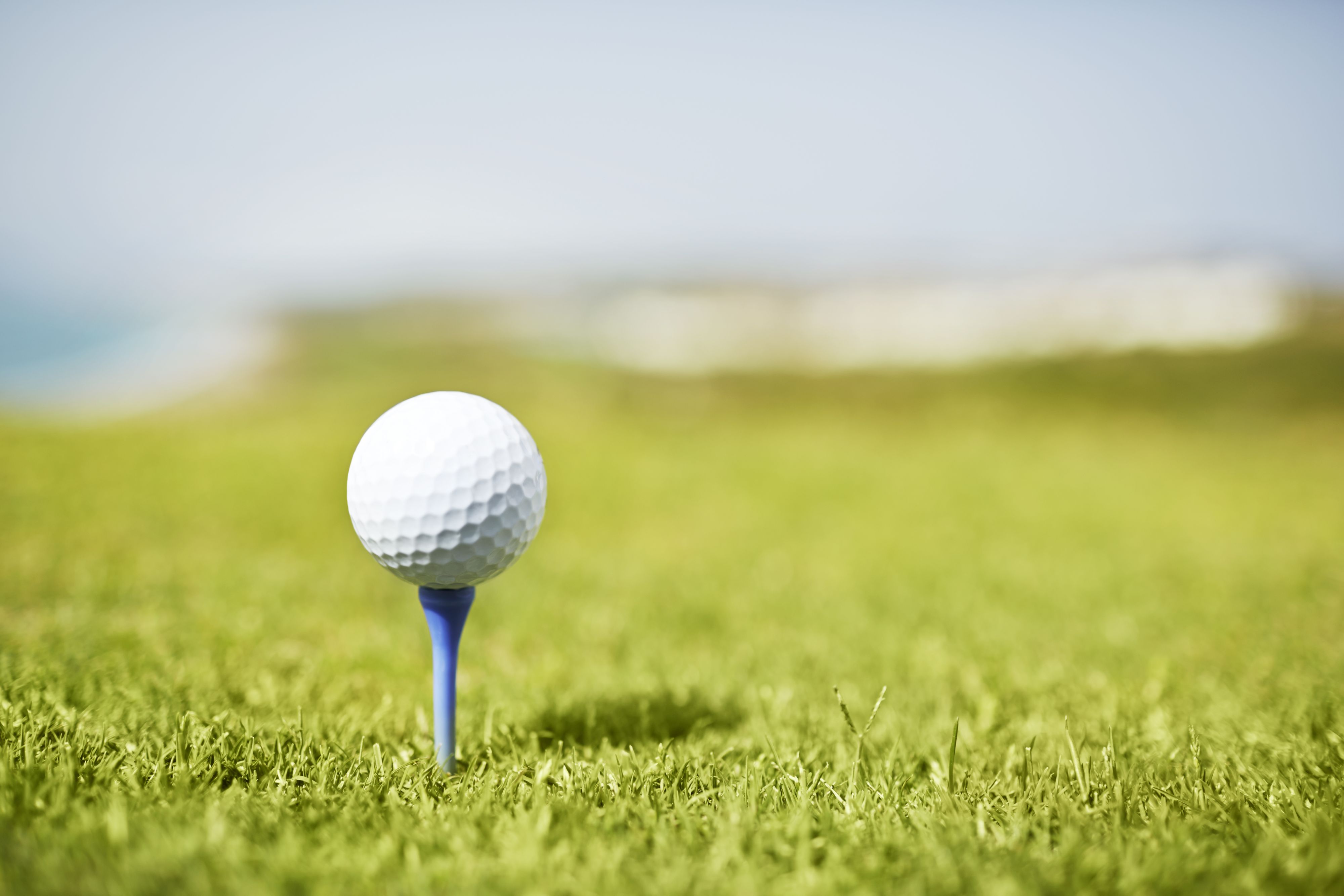 Golf ball on a blue tee