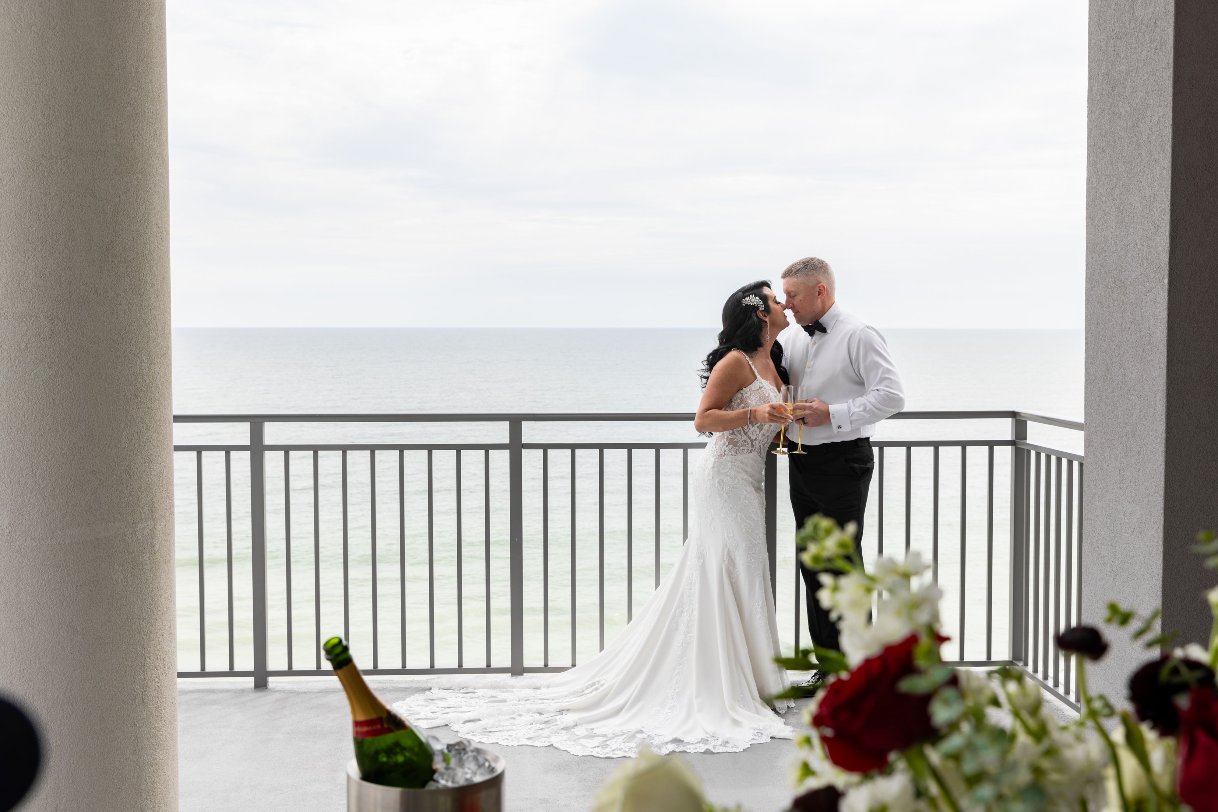 Couple embracing on a balcony overlooking the ocean