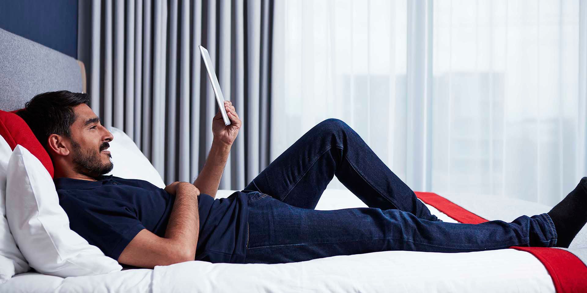 Man reading on a bed