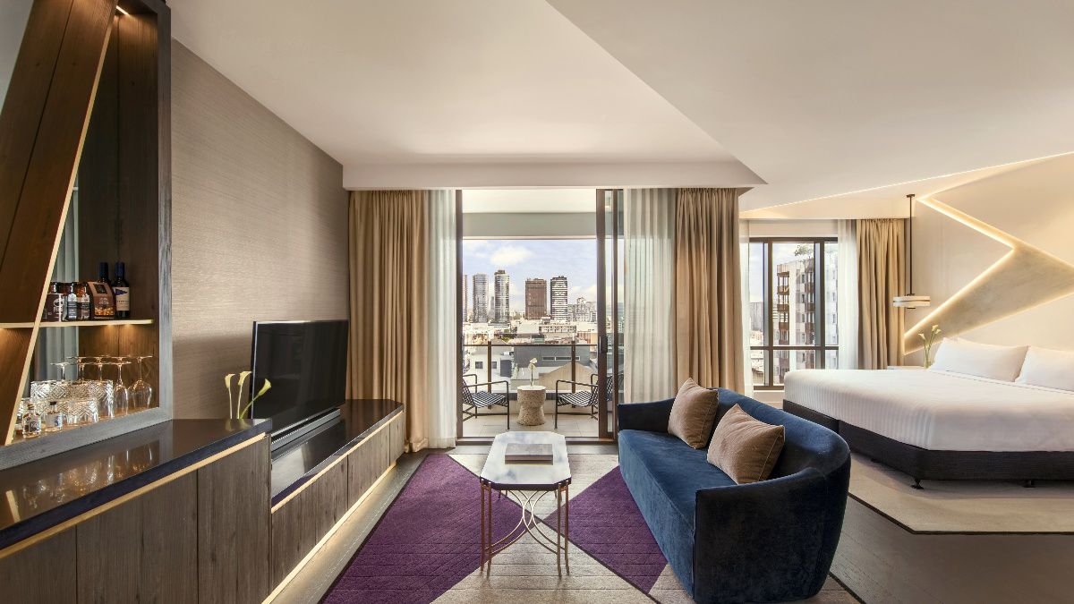 Modern hotel suite with lounge and city views