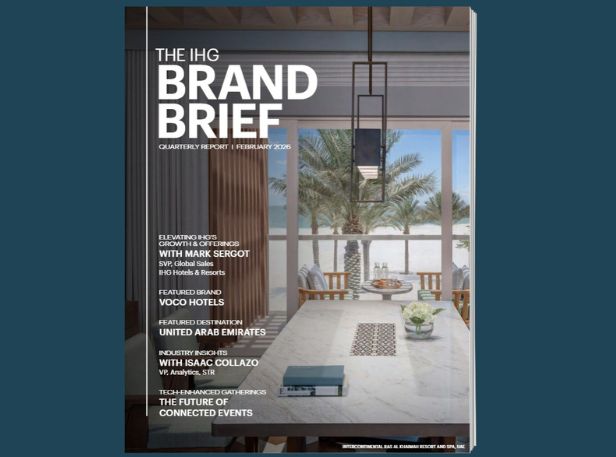 Modern dining space with floor-to-ceiling windows and coastal view.