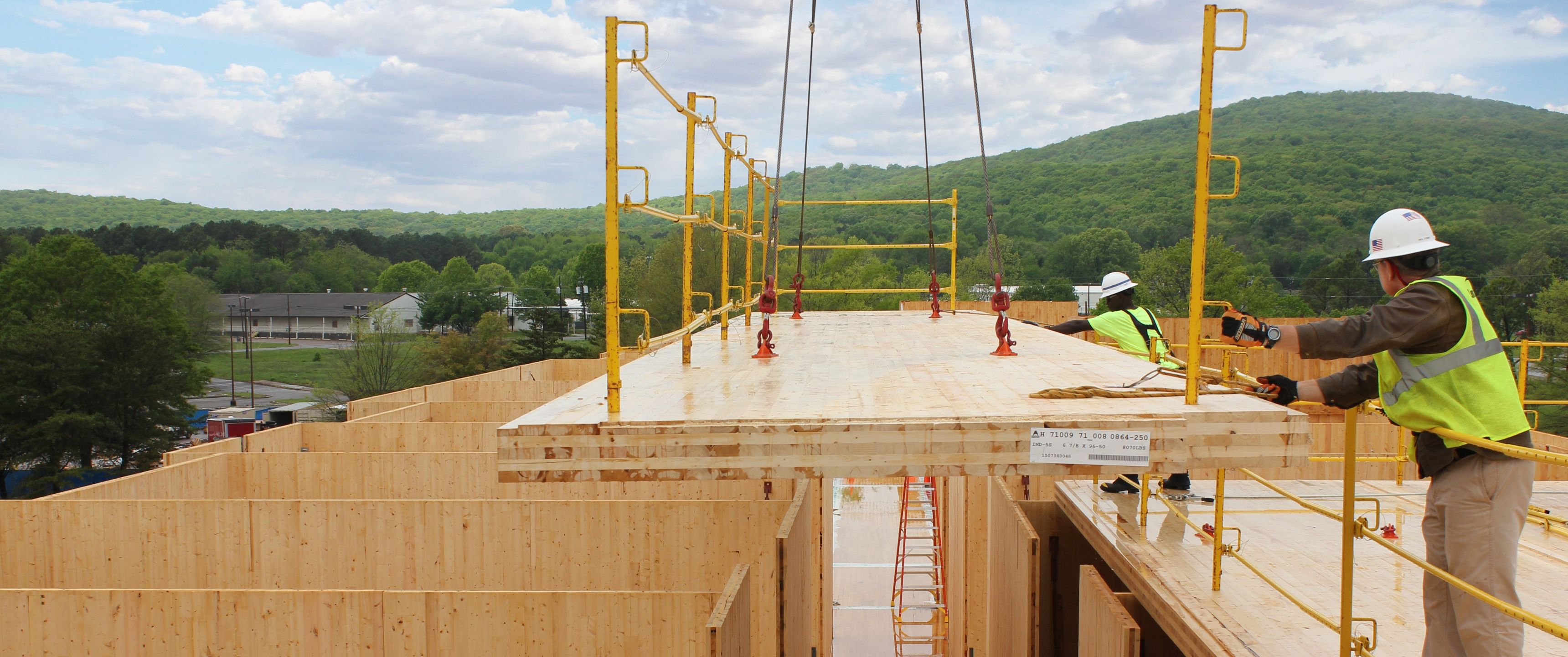 Construction site with trees and blue skies in the background.