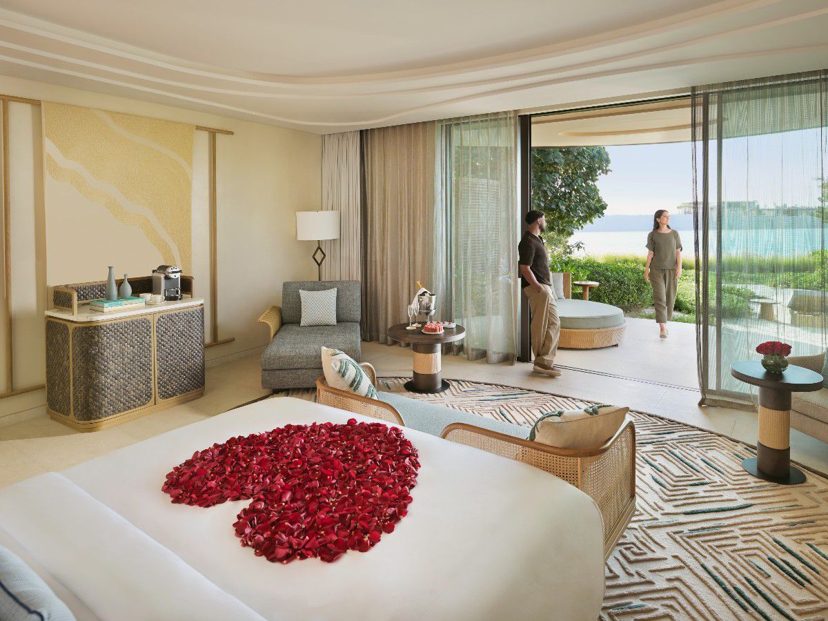 Luxurious resort suite with romantic rose petal bed