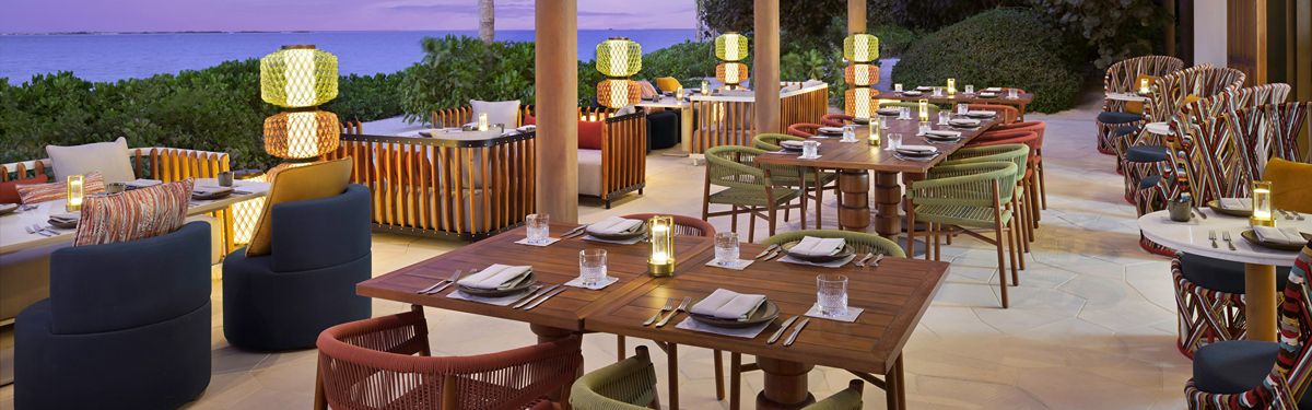 Outdoor restaurant terrace with beautifully set dining tables.