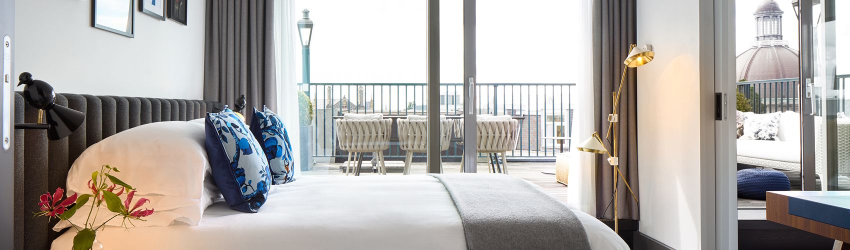 An upscale hotel suite with an outdoor balcony