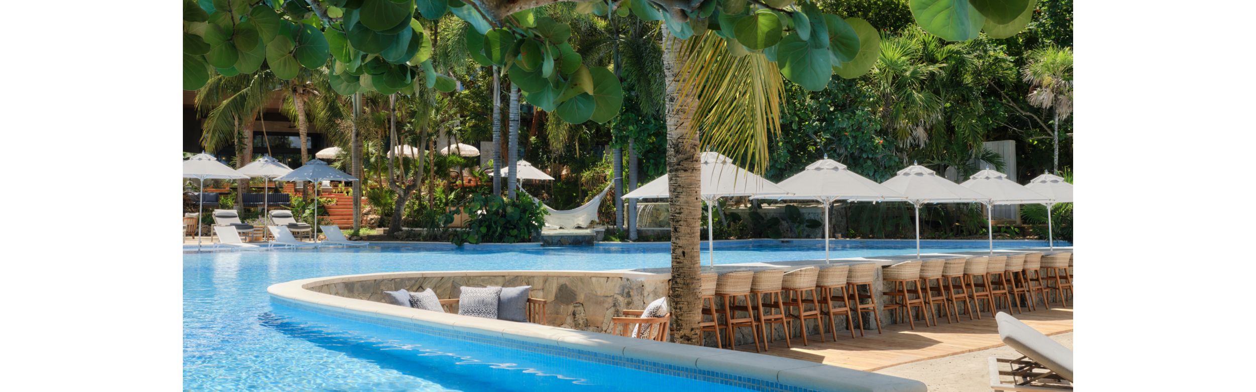 Sparkling outdoor pool and lounge chairs with umbrellas