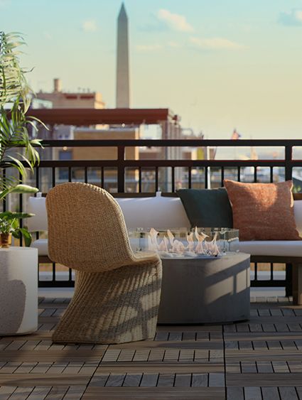 outdoor deck with cocktail tables and lounge seating at sunset