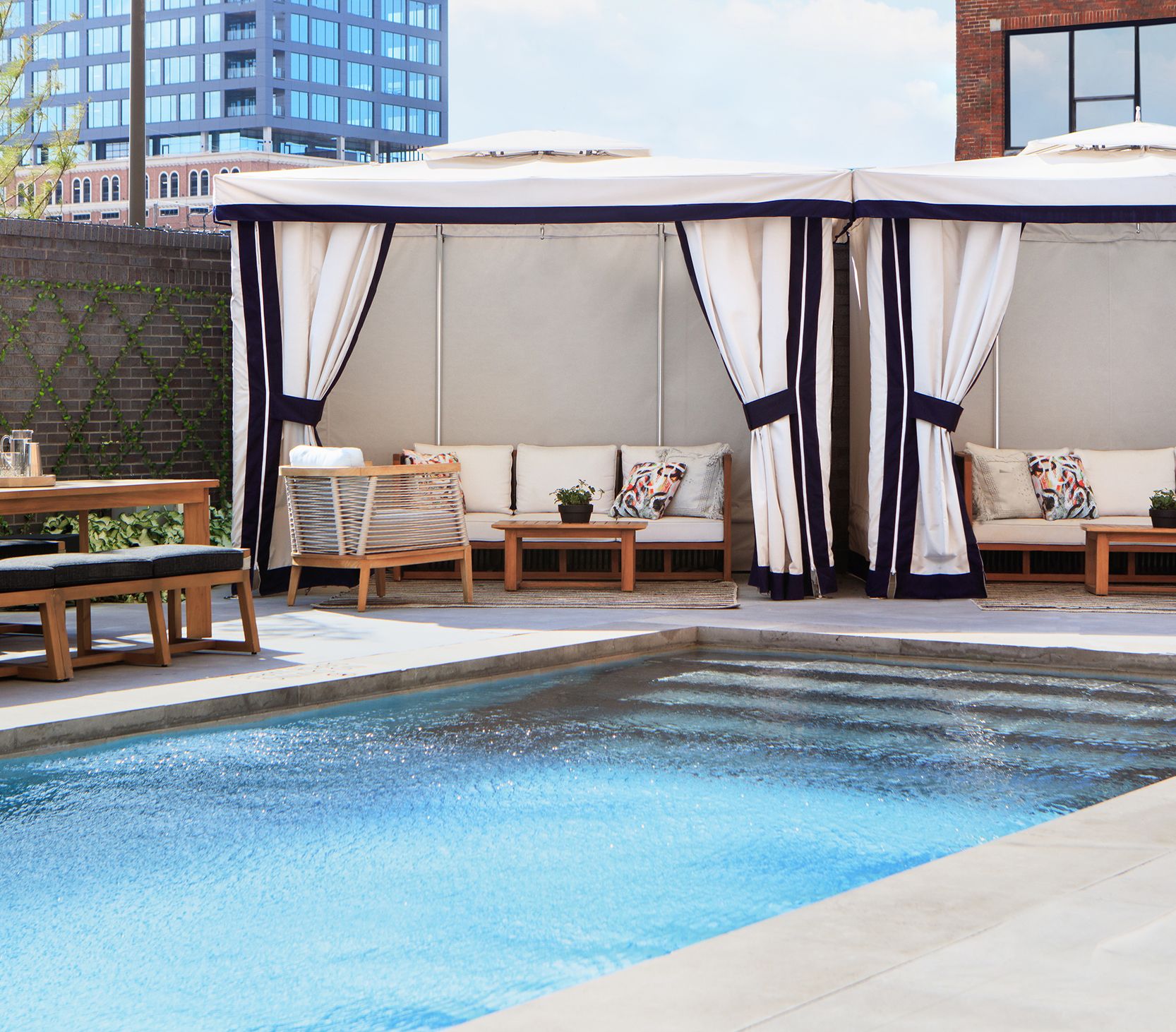 pool deck surrounded by crisp white cabanas and lounge seating