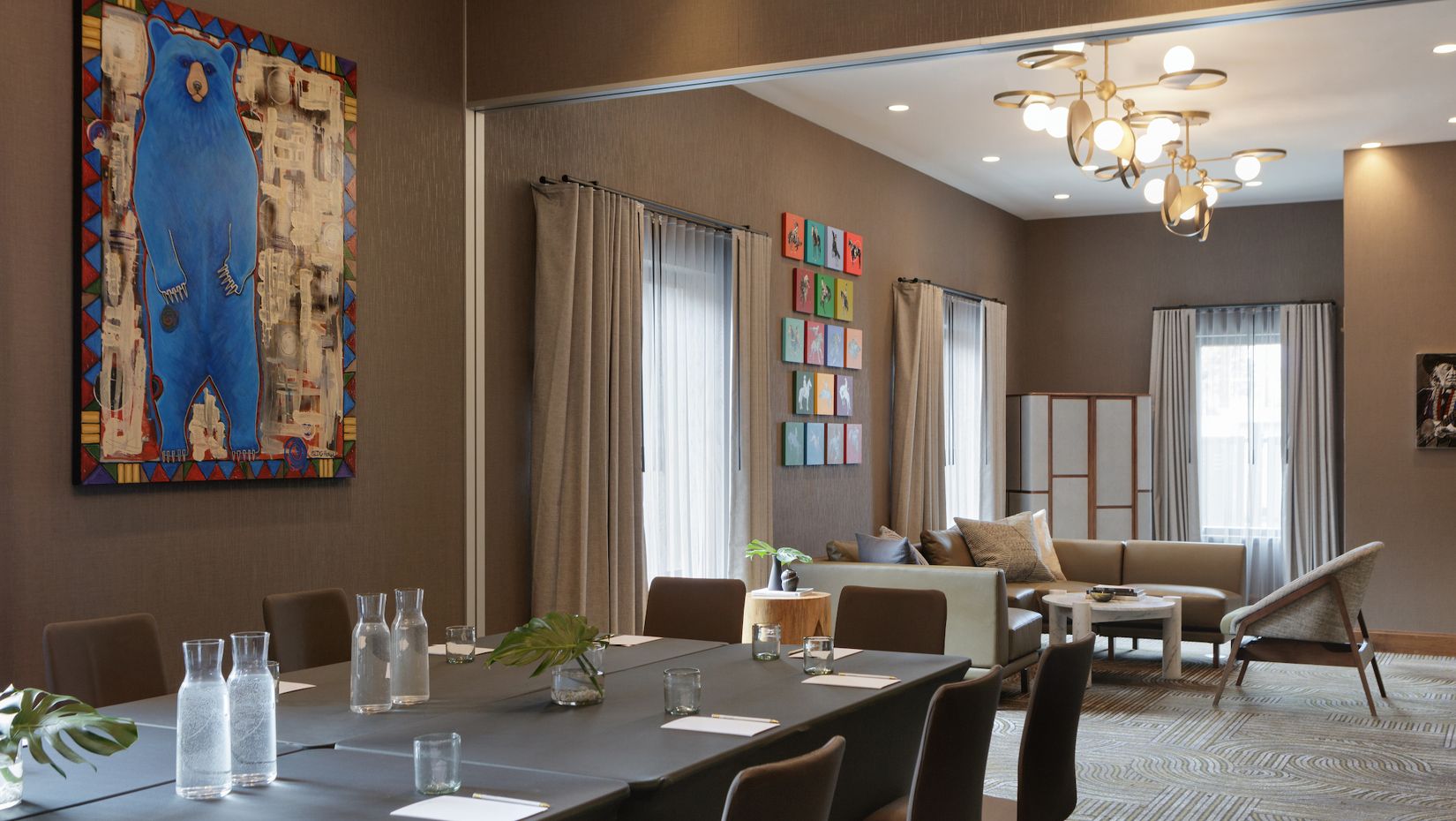 boardroom set with water and colorful artwork on the walls