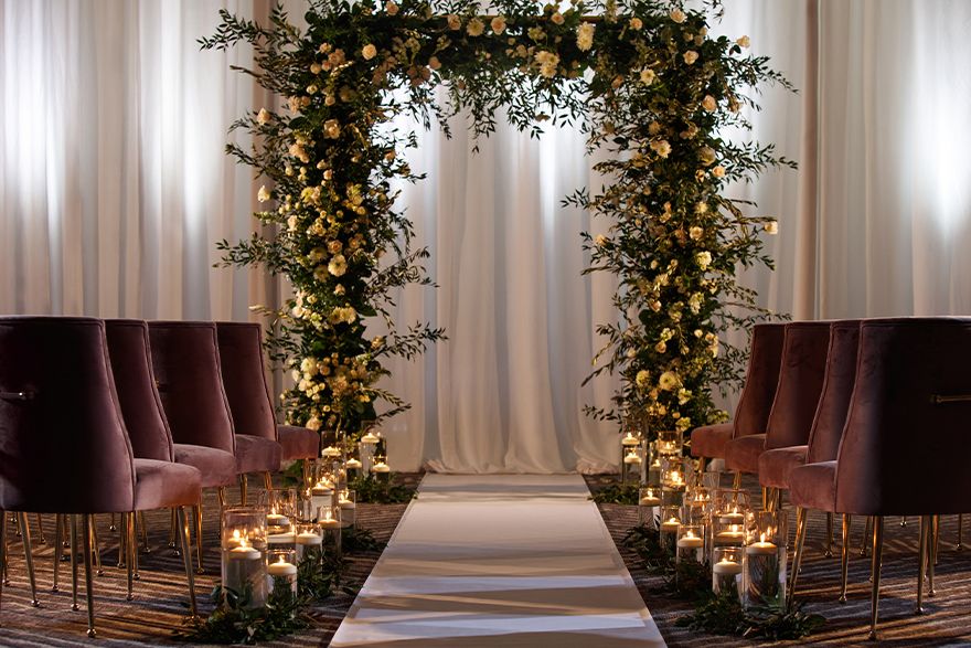 wedding ceremony set up with arch of flowers