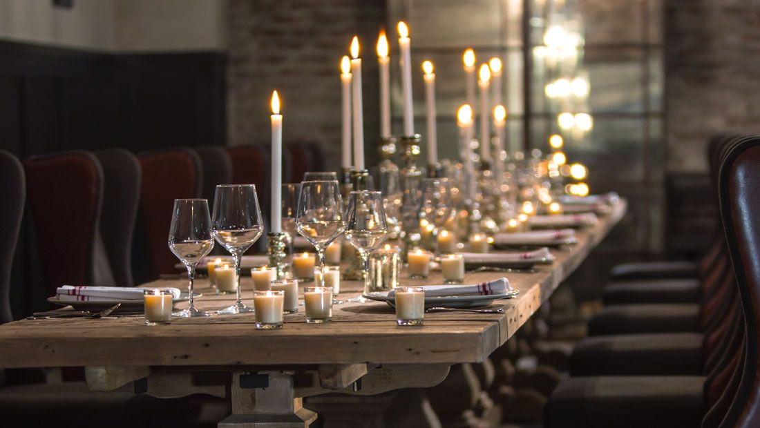 a beautiful candlelit dinner in a dark and cozy room