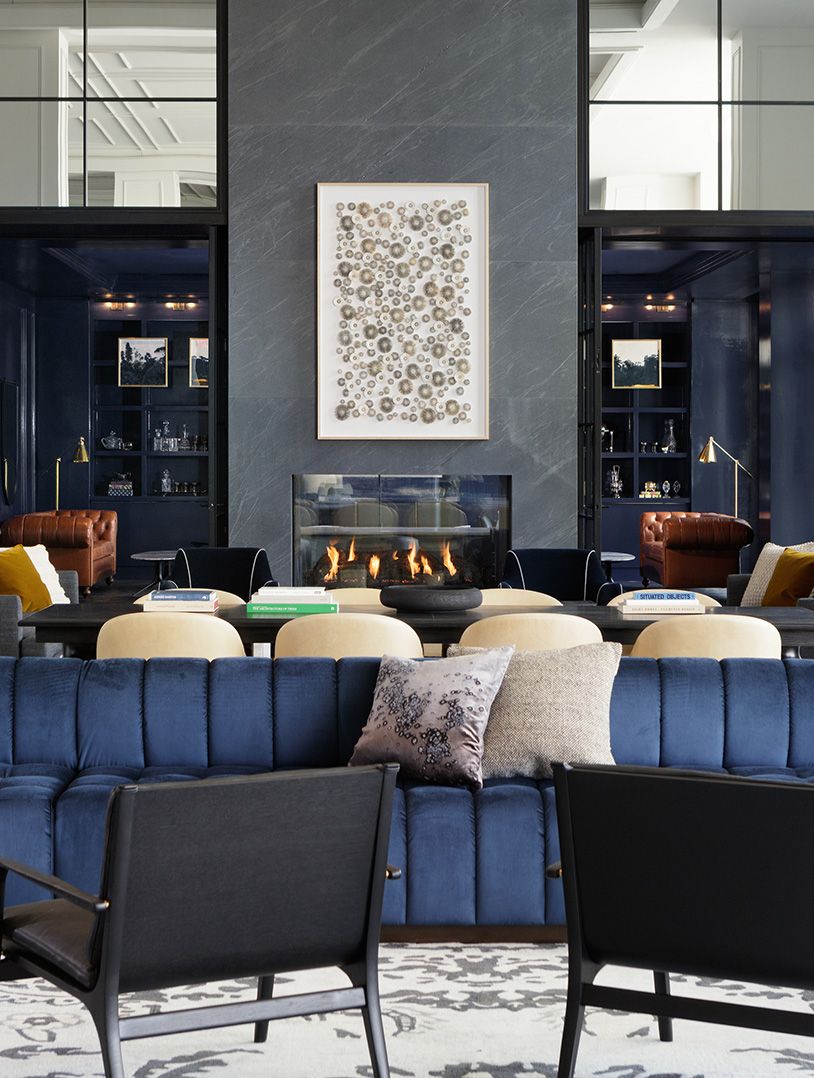 lobby living room with fireplace and plush navy couches