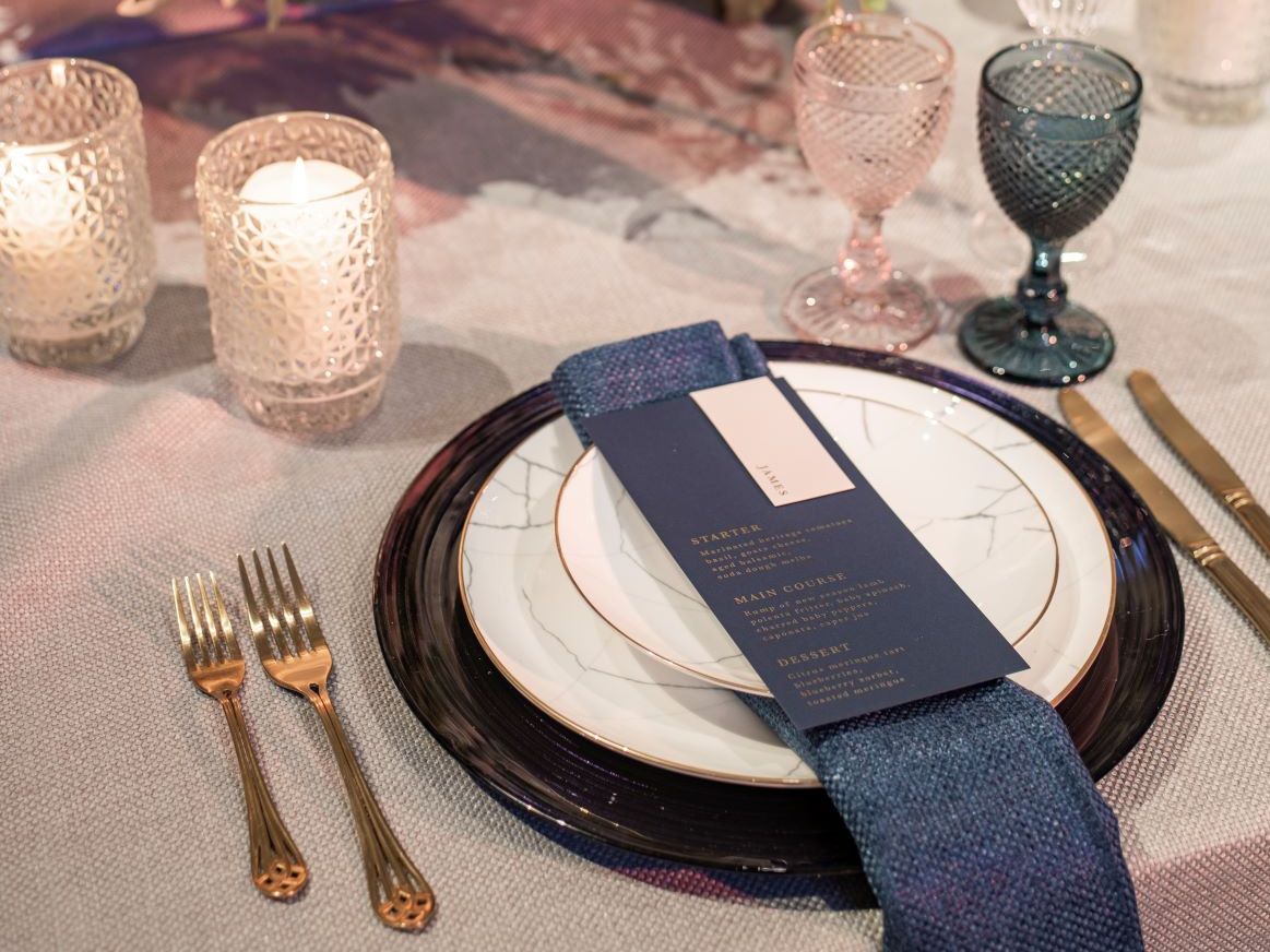 Tablescape with charger, blue glassware and silverware